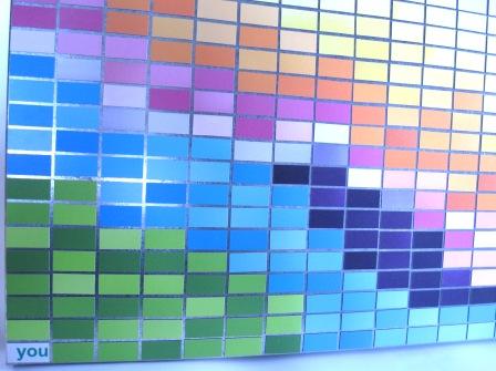 Light reflecting on magnet art titled 'Weather'.